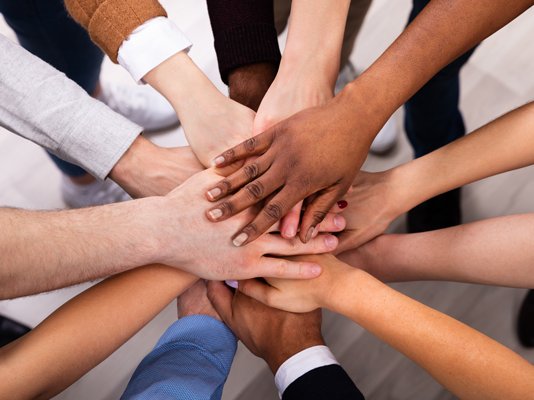 A team all putting their hands together