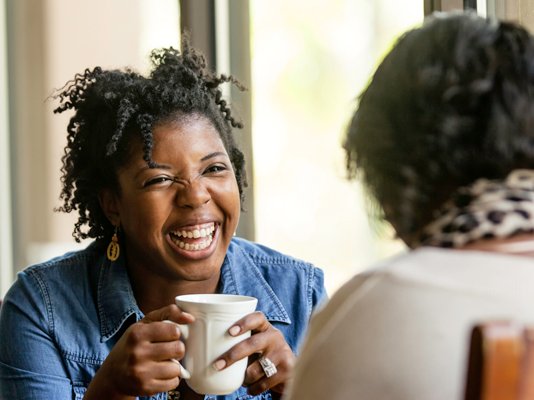 A befriender volunteer having a cup of tea with their companion