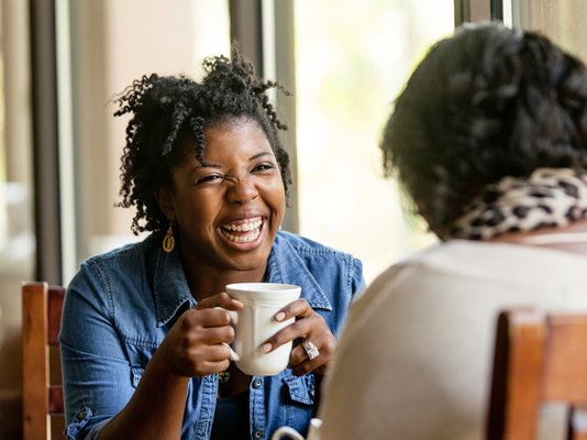 A befriender volunteer having a cup of tea with their companion