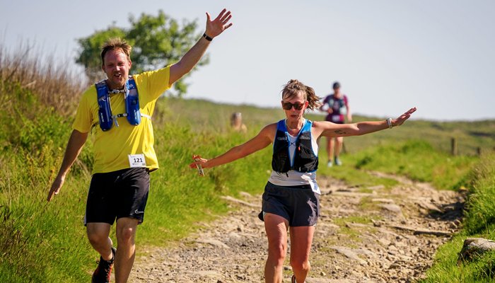 Two runners with their arms in the air during the Bronte Half Marathon race