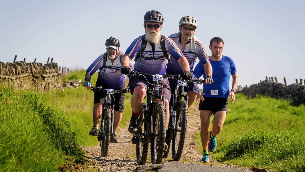 A group of mountain bike riders racing through the countryside for the Bronte Off Road Bike Challenge