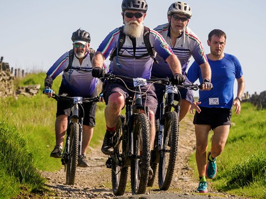 A group of mountain bike riders racing through the countryside for the Bronte Off Road Bike Challenge
