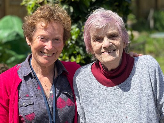 Befriender volunteer Cathy with Dot in the hospice garden