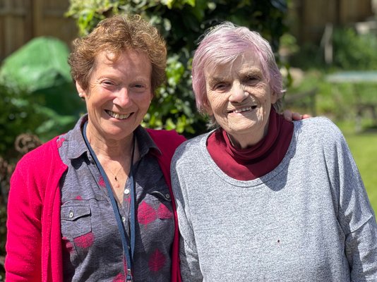 Befriender volunteer Cathy with Dot in the hospice garden