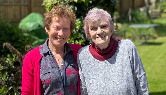 Befriender volunteer Cathy with Dot in the hospice garden