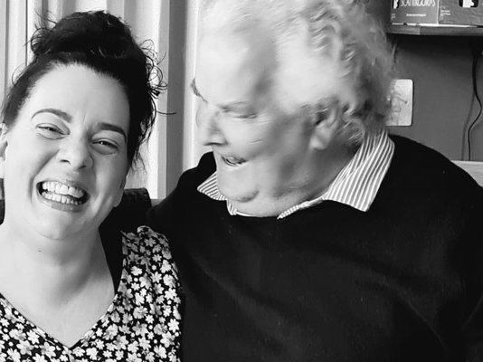 Sue Ryder volunteer, Claire, laughing with her dad at home