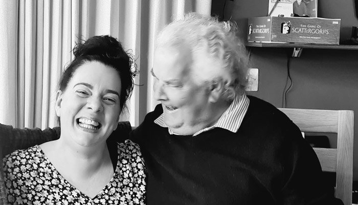 Sue Ryder volunteer, Claire, laughing with her dad at home