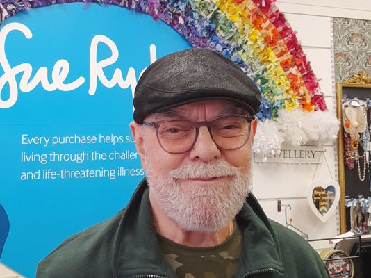 Volunteer, Colin, in a Sue Ryder charity shop
