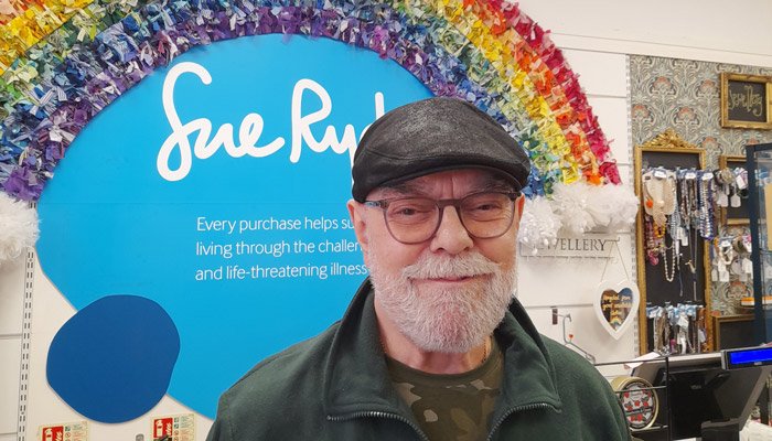 Volunteer, Colin, in a Sue Ryder charity shop
