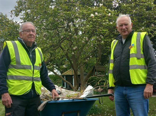 Garden volunteers, David and Richard, next to a wheelbarrow in the St. John's Hospice garden
