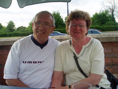 Doug with his arm around Debbie. They are smiling toward the camera.