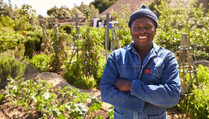 A smiling garden volunteer in an allotment