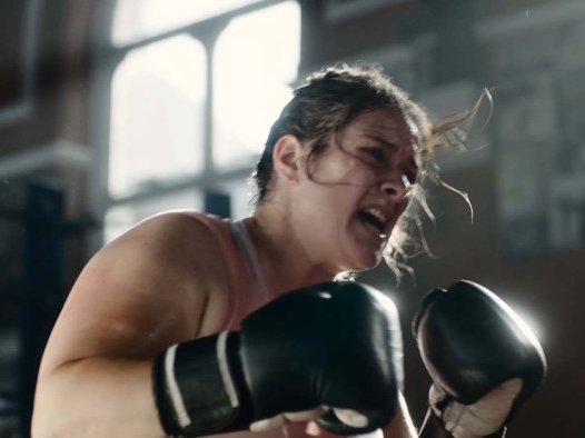 Image of a woman hitting a punchbag from the Sue Ryder Grief Kind campaign TV ad