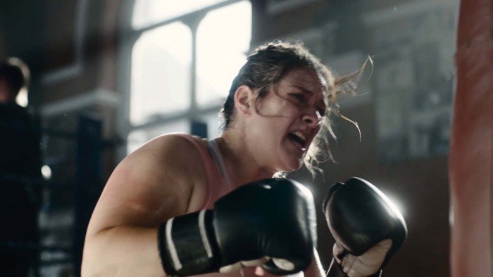 Image of a woman hitting a punchbag from the Sue Ryder Grief Kind campaign TV ad
