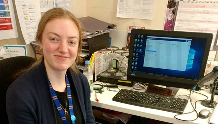 Sue Ryder shop volunteer, Izzy, at her work desk