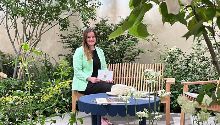 Garden Designer Katherine Holland, sitting in the Sue Ryder Grief Kind Garden with her Gold Award