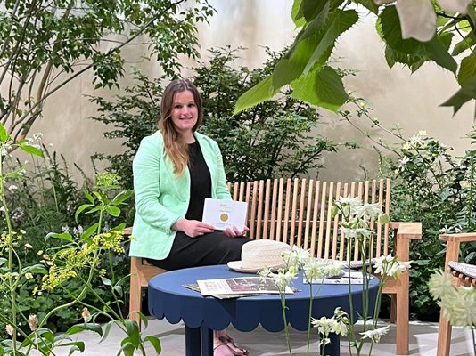 Garden Designer Katherine Holland, sitting in the Sue Ryder Grief Kind Garden with her Gold Award
