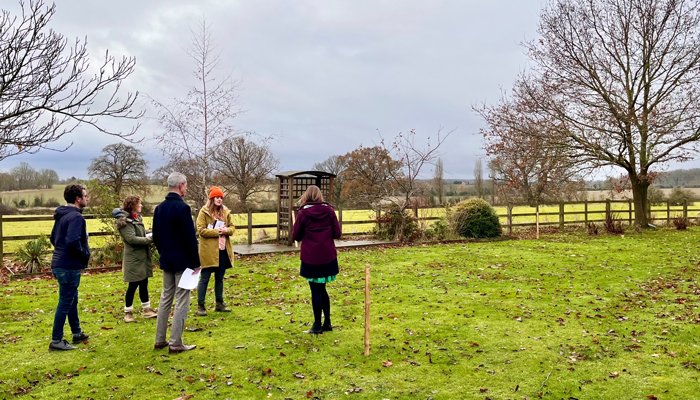 Garden Designer Katherine Holland, with St. John's Hospice staff, in the field where the Grief Kind Garden will be moved to