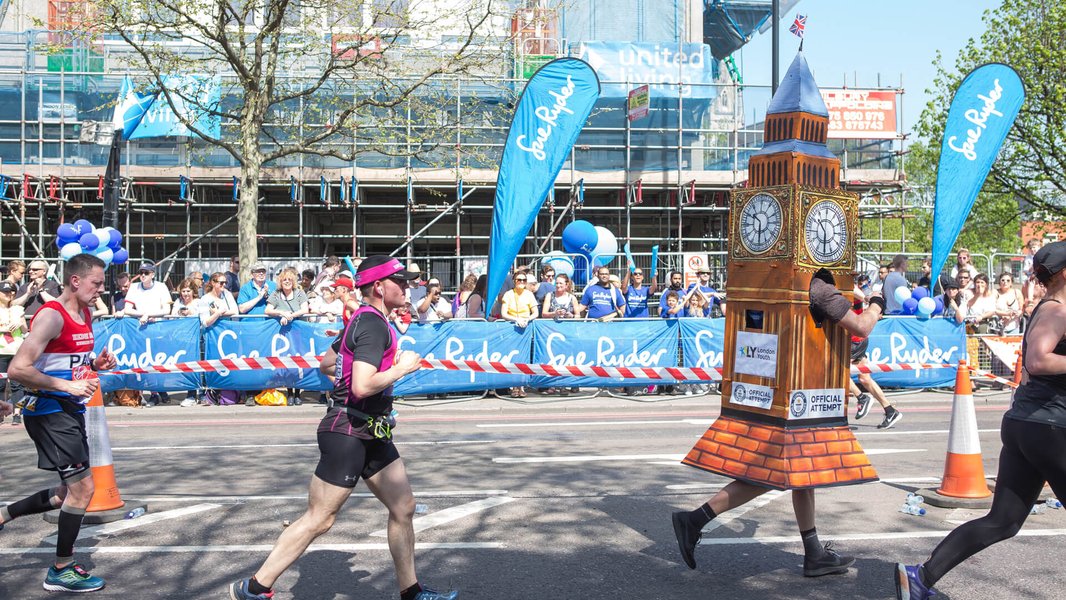 Runners going along the London Landmarks route, with Sue Ryder banners in the background