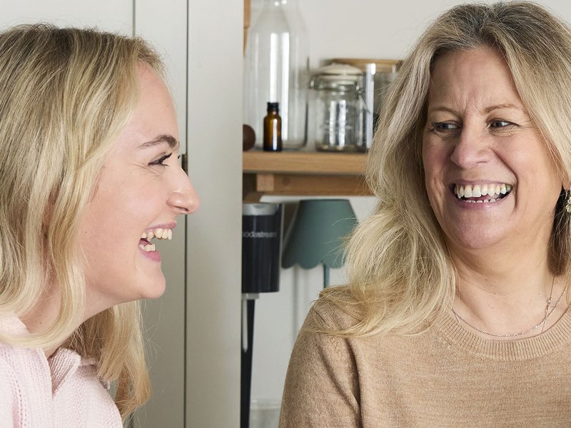 A daughter and mother laugh together