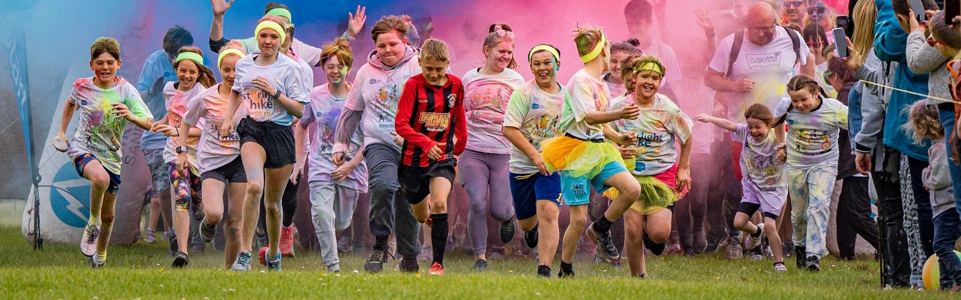 Runners covered in paint, at the starting line