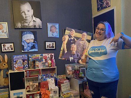 Pippa Tinsley in her Sue Ryder t-shirt surrounded by pictures of her family