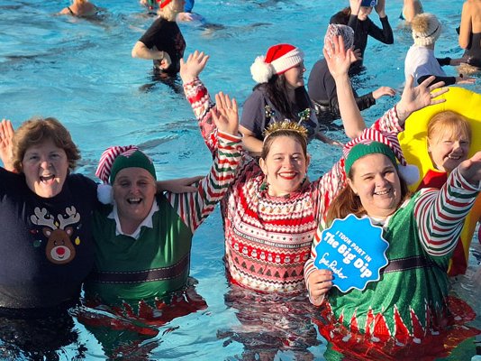 A group of celebrating swimmers in the pool for the Big Dip Cheltenham