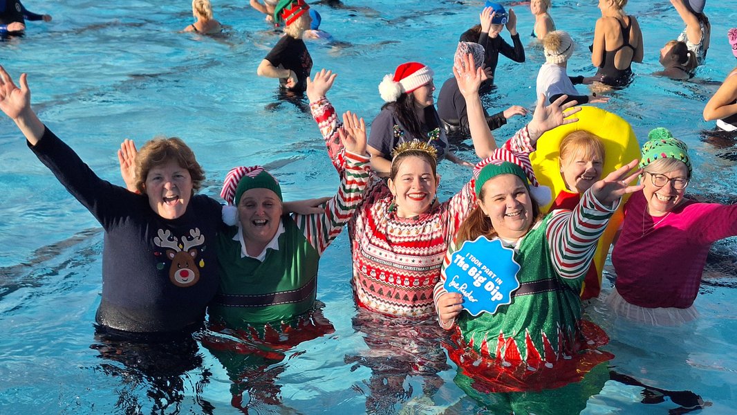 A group of celebrating swimmers in the pool for the Big Dip Cheltenham