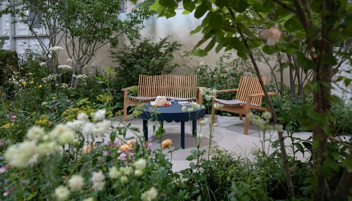 Maria Savoskula's photo of the Sue Ryder Grief Kind Garden, with a table and chairs surrounded by flowers and plants