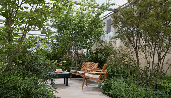 Maria Savoskula's photo of the Sue Ryder Grief Kind Garden, showing a table and benches surrounded by flowers and plants