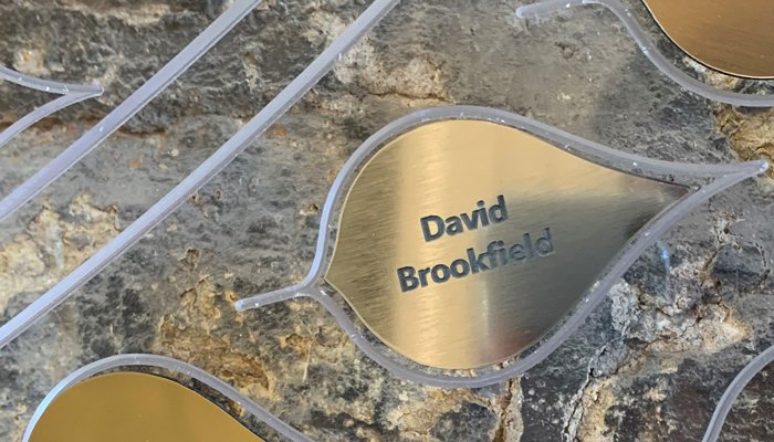 Brass Memory Tree leaves with names of loved ones in black text