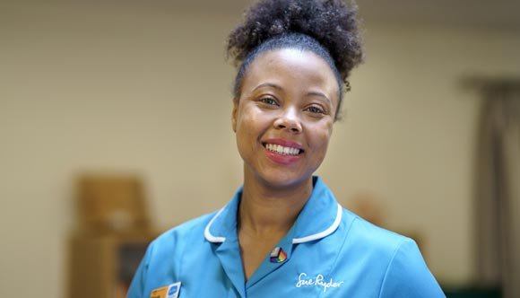 A Sue Ryder Nurse wearing a Rainbow Badge on her uniform