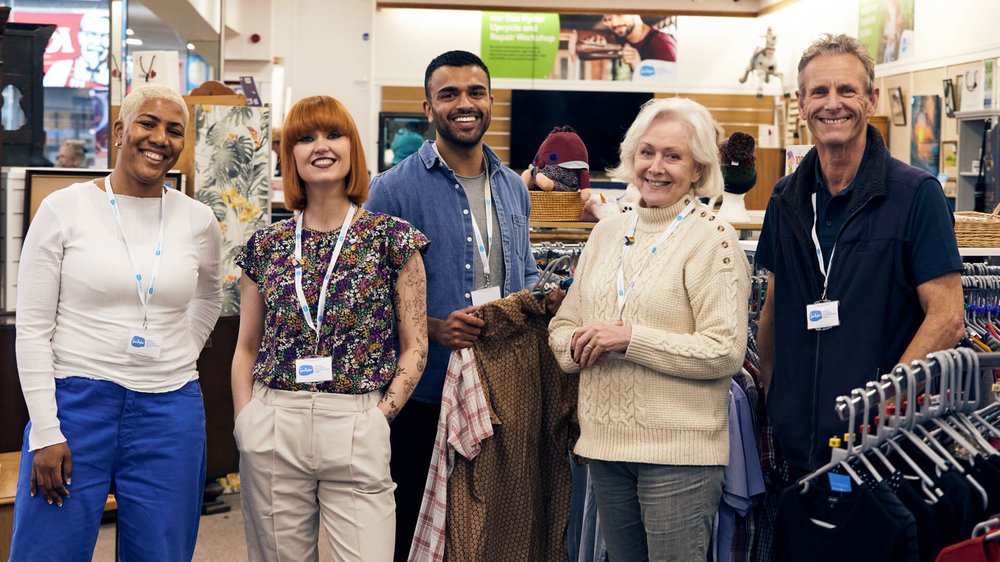 A group of Sue Ryder retail volunteers in a charity shop