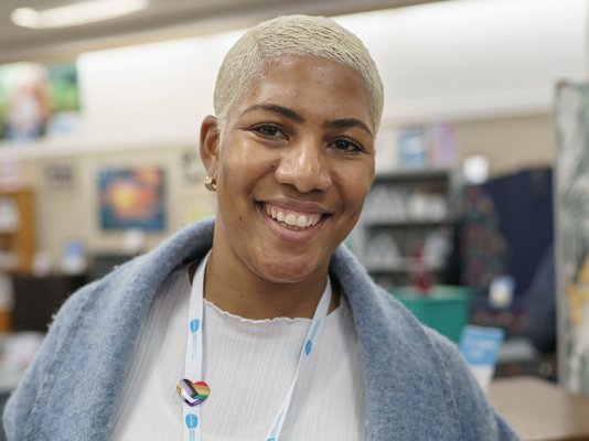 A smiling Sue Ryder retail volunteer on the shop floor