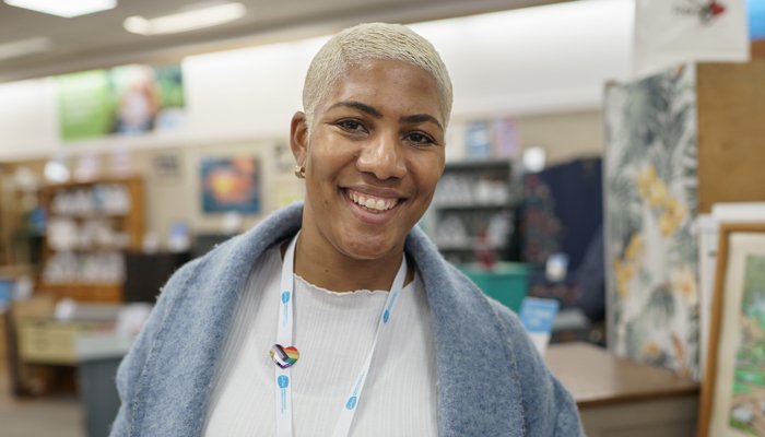 A smiling Sue Ryder retail volunteer on the shop floor