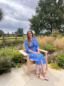 Katherine Holland sits in a garden