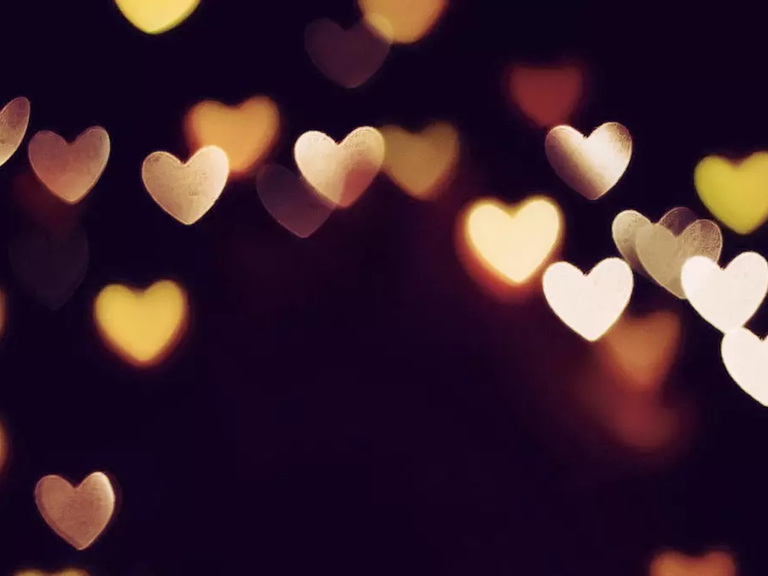 Photo of blurred heart lights on a dark background
