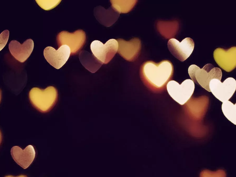 Photo of blurred heart lights on a dark background