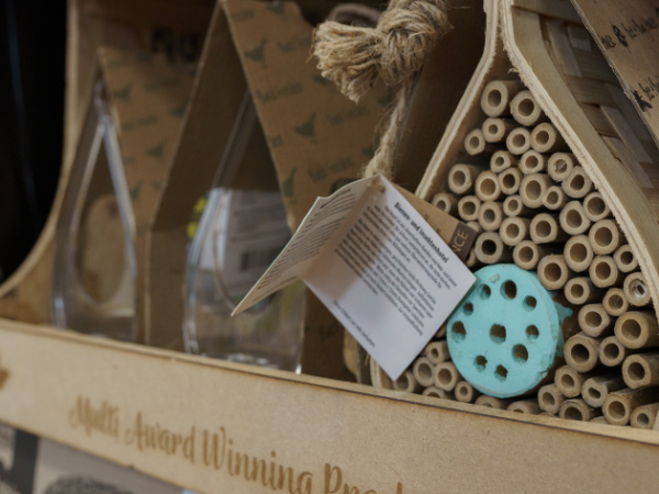 Wooden insect hotel on a shelf in a shop