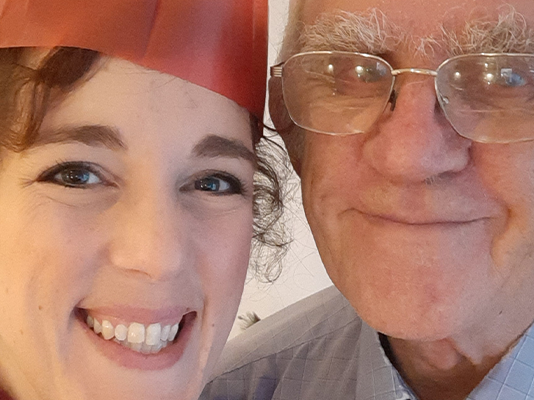 Katherine and her dad wearing paper hats