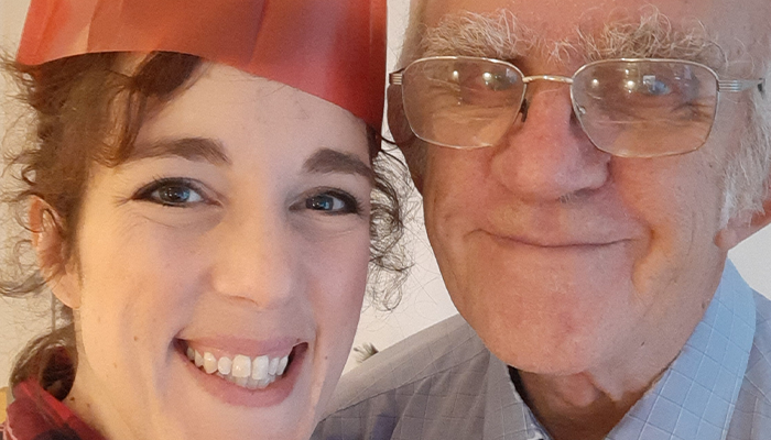 Katherine and her dad wearing paper hats