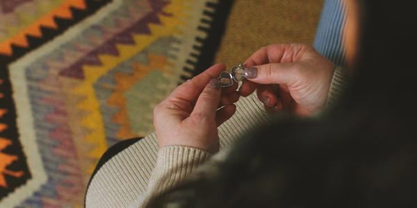Close-up of Lisa Riley holding a locket containing photos of her and her mum