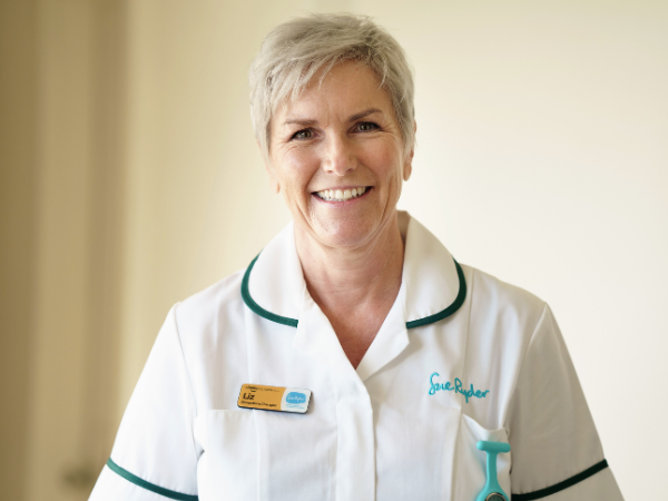 Liz, a Sue Ryder Occupational Therapist, in her white uniform