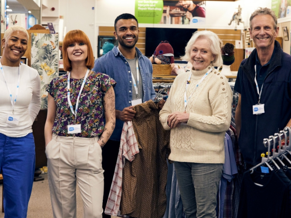 Group of smiling 5 retail staff and volunteers