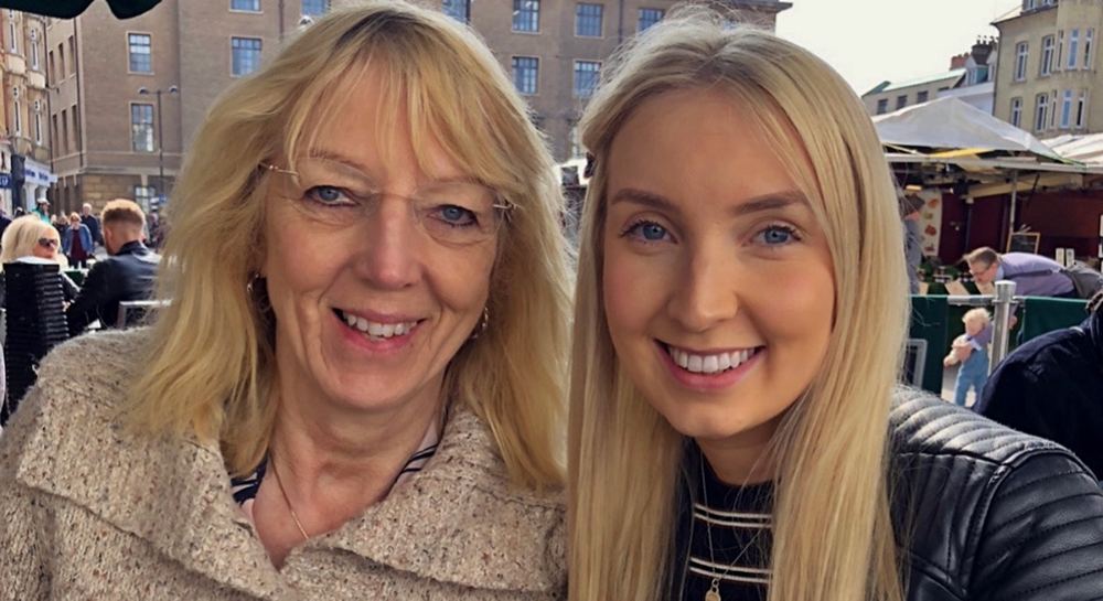 Sophie and her mum smile into camera.