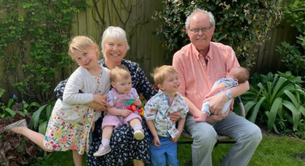 Steve Satterthwaite with his wife and 3 grandchildren, smiling and posing