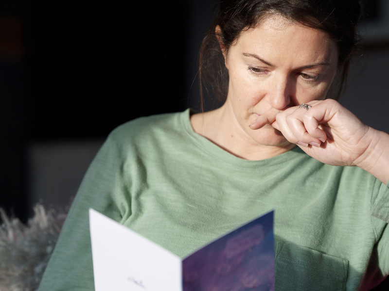 Women looking at sympathy card.