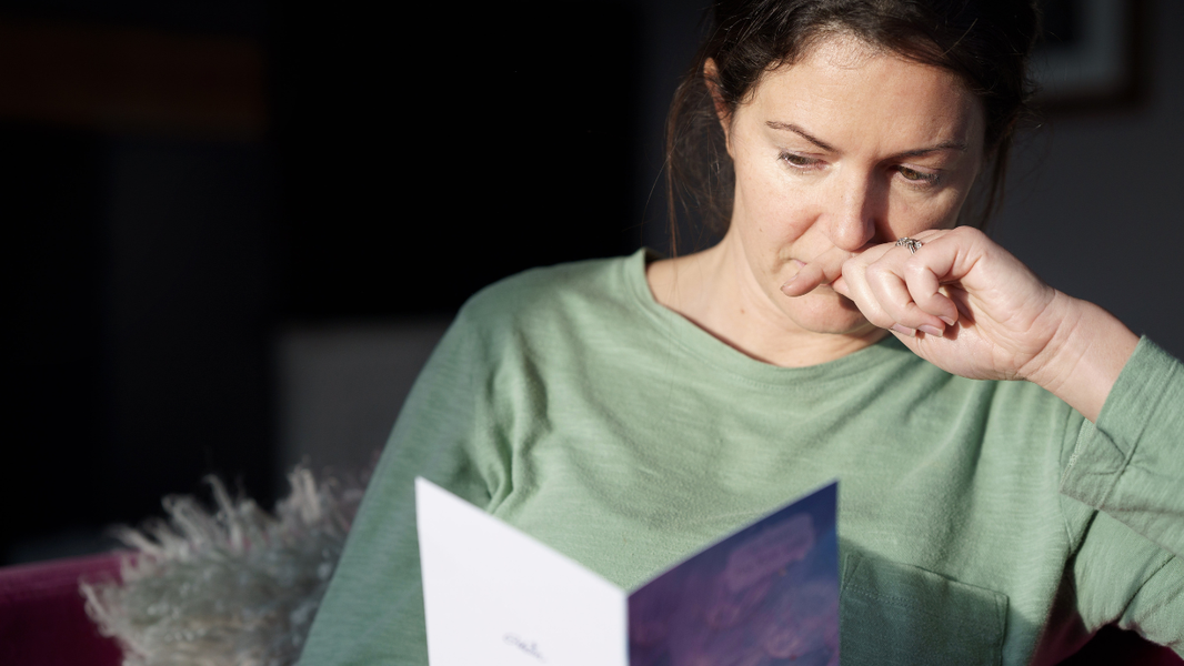 Women looking at sympathy card.